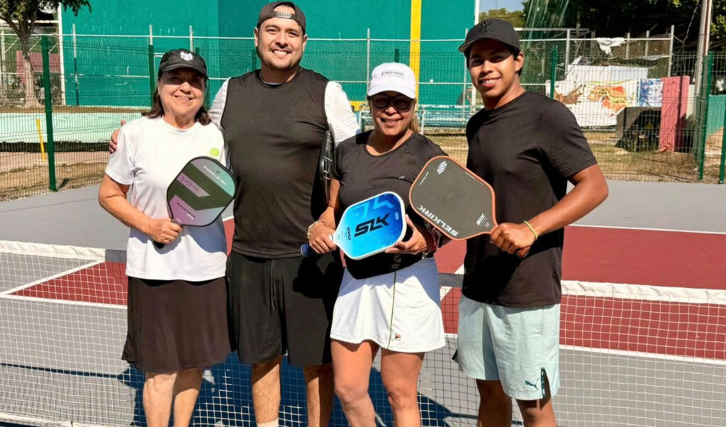 A group of four pickleball players posing on the court at Pata Salada in Mazatlán.