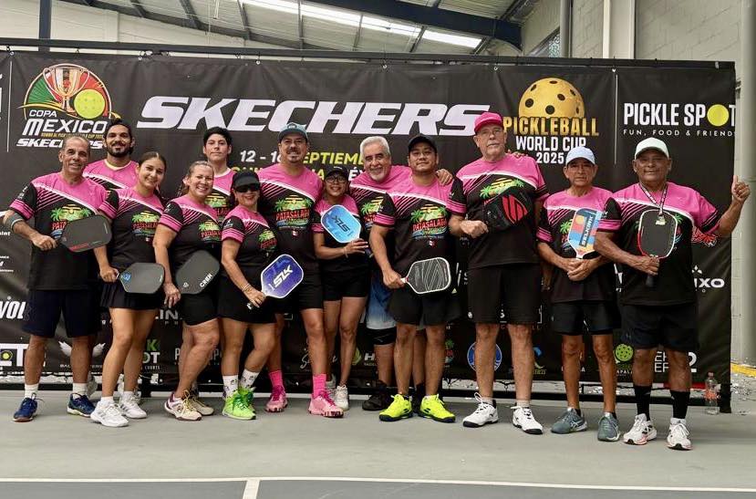 A large group of pickleball players in matching pink and black Pata Salada team shirts posing with their paddles in front of a Skechers and Pickleball World Cup 2025 backdrop.